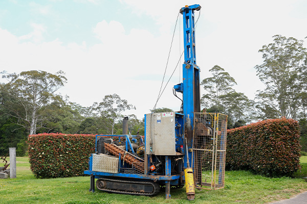 Hunter Geotechnical Services track-mounted drill rig on a tight-access site